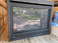 Front view of black metal fireplace insert on truck bed