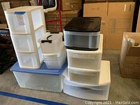 Photo showing stacked plastic storage drawers and bins of various sizes and colors.