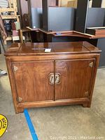 Full view of the wood buffet server showing overall design, wood grain finish, and brass hardware on front doors.