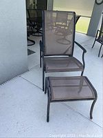 Patio chair and footstool viewed from above and front angle showing mesh material and metal frame.