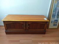 Front view of cedar chest showing oak top and cedar body with brass-tone hardware