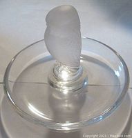 Clear glass dish with frosted glass hawk, viewed from above showing the full shape of the dish and mounted hawk