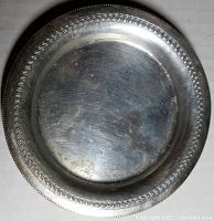 Top view of 4.25" round silver tray showing patterned rim and overall condition