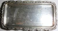 Rectangular tray with ornate scrolling rim