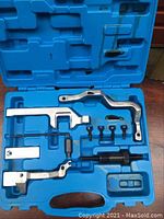 Photo of the opened blue plastic carrying case showing the timing tool set arranged inside.