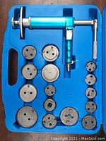 Full set showing pneumatic brake pad tool and 15 adapters inside blue molded case