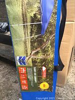 Label showing canopy set up in outdoor park setting, highlighting UV protection and size coverage.