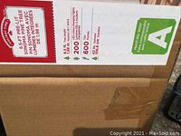 Photo of the product label and specifications on the shipping box showing the tree dimensions, light count and model name.