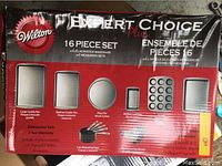Photo of the red and black Wilton box with description of included baking pans and utensils in the 16 piece set.