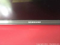Close-up of the front bezel with Samsung logo on the TV.