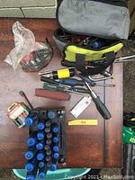 Full overview of the tools laid out including screwdrivers, pliers, and carrying bag.