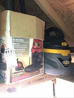 Two wet/dry shop vacuums with one in original box and both with hoses and cords.