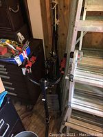 Bike rack installed on stand with multiple fishing rods behind