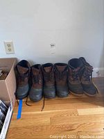 Three pairs of winter boots aligned side by side showing boots details and condition.