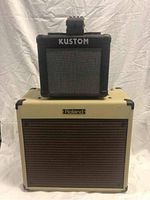 Stacked equipment: black Kustom KGA-10 on top of Roland Blues Cube BC-30
