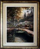 Full view of the framed oil painting showing a landscape scene with a pond, trees, flowers, and a bench.