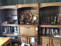 Full view of shelving units containing ship-themed decor and other items including books and bud vases.