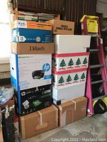 Stack of boxes including holiday tree box and other packaging