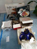 Photo showing various boxed and loose sets of serving dishes and trays, including Craftware buffet server and Shell serving set in original packaging