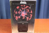 Front of original box showing red and blue plasma ball graphic with product name