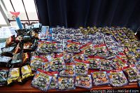 Wide view of multiple blind bag packs including Minis and other series, arranged on a flat surface showing quantity and variety.