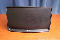 Front view of the Pioneer wireless speaker, showing the full grill and curved edges.