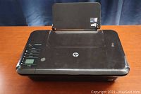 Front view of HP Deskjet 3050 showing top and control panel with visible surface scratches.