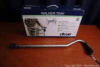 Photo of Airgo adjustable cane and boxed Drive walker tray on wooden surface