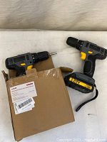 Two Tippelex 20V Max lithium ion cordless drills shown with one inside original box.
