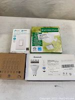 Photo showing all four lighting related items for sale: smart switch, slim LED panel, GU10 bulb and set of Edison bulbs