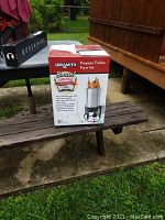 Front view of Grillsmith Propane Turkey Fryer Set box with image of fully assembled fryer showing 30 qt aluminum pot, burner stand, and food cooking inside pot.