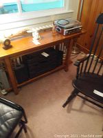 Photo of wooden table with Crossley record player on top and Kenwood amplifier on shelf below