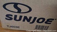 Photo of the sealed cardboard box with SunJoe logo and model number TJ603E visible.