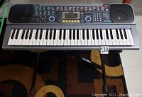 Casio CTK-601 electronic keyboard on stand, showing front controls and keys