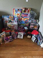 Wide view of many boxed toys including Pie Face Cannon, remote control cars, infant and female geared toys, and various boxed sets