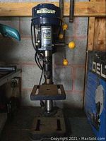 Full front view showing base, column, table and head