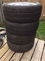 Stack of four tires with wheels visible