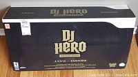 Front view of the sealed black and gold DJ Hero Renegade Edition bundle box for Nintendo Wii, featuring logos of Jay-Z and Eminem