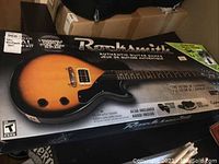 Rocksmith Authentic Guitar Games box showing Epiphone guitar graphic and bundle contents