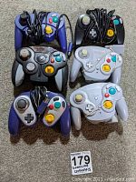 Overview of six GameCube controllers on carpet