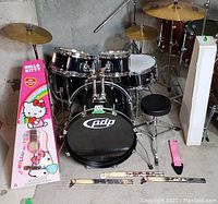 Overall lot including drum kit, Hello Kitty guitar box, strap and drumsticks