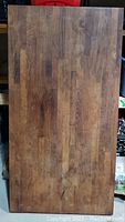 Front view of dark stained side of wooden cutting board