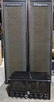 Two Traynor speaker cabinets side by side with RCA amplifier in front