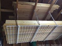 Overhead rack loaded with 2x6 and 2x4 lumber planks