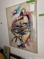 Full view of the wall art showing the abstract figure and acrylic framing.