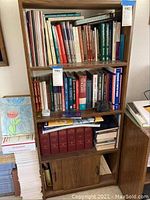 Full view of wooden bookshelf holding multiple books.