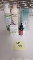 Photo showing all five skin care items together including boxed Algenist cleanser, Aveeno body wash, Dove deodorant, Kate Somerville exfoliator, and Organic Remedy cleanser.