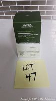 Boxed Aveda Botanical Kinetics Intense Hydrating Rich Creme on top of boxed Aveda Tulasara Wedding Masque with 'Lot 47' label nearby on a counter