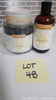 Photo showing the three Arbonne products in the lot including the Awake shower gel bottle, the Mandarin Cashmere body cream jar, and the Awaken body scrub container.