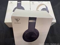 Front view of three boxed Dooaus headphones, showing Care 1 and Care 2 versions.